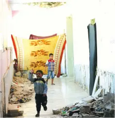  ?? (Reuters) ?? AN INTERNALLY DISPLACED Syrian boy who fled Deir al-Zor runs in a school, a former ISIS base, in the city of al-Bab yesterday.