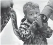  ??  ?? Spencer Finn is not too sure about the snakes at the “Diversity of Living Things” event.