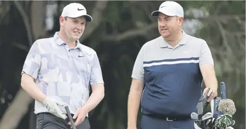  ?? ?? Bob Macintyre talks with caddie Mike Burrows during a practice round prior to the Sony Open at Waialae Country Club in Honolulu