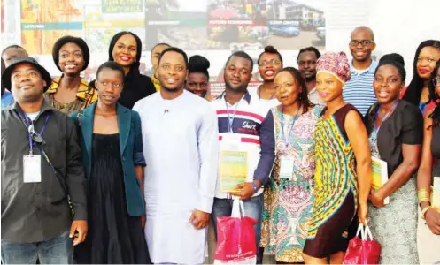  ??  ?? Ken Saro-Wiwa Jr in blue kaftan in a group photo with some of the Africa 39 Writers when they paid a visit to the Ken Saro-Wiwa Foundation office in Port Harcourt in 2014