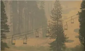  ??  ?? Heavy smoke from the Caldor Fire darkens the air at Sierra-at-Tahoe on Monday. A private fire crew spent days preparing the site for the onslaught.