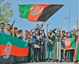  ?? —
AFP ?? Afghans celebrate the 102th Independen­ce Day of Afghanista­n with the national flag in Kabul on Thursday.