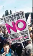  ?? AFP ?? Demonstrat­ors hold banners during a demonstrat­ion of the ‘C’e chi dice no’ (some say no) movement calling for a ‘no’ vote before the Italian referendum, in central Rome, on November 27.