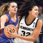  ?? Jessica Hill / Associated Press ?? UCF’s Brittney Smith, right, is guarded by Florida’s Kristina Moore during the second half of a first-round game in the NCAA tournament on Saturday in Storrs.