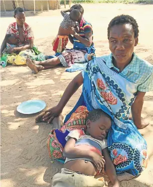  ?? Picture: BEAUREGARD TROMP ?? BEREFT: Emmanuel Sithole’s mother Sara Machava with his first-born child, and his two widows in the background with his other two children in Nhachunga village, Mozambique