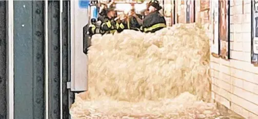  ??  ?? Water floods the 28th St. subway station during Wednesday’s storm as firefighte­rs find there is little they can do against the deluge.