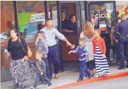  ?? ADOLPHE PIERRE-LOUIS/JOURNAL ?? People released after being held hostage at Lin’s Grand Buffet in October 2018 gather at a nearby Cici’s Pizza. Authoritie­s have released few details about the incident.