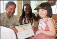  ??  ?? Lily-Anne Wright, 4, receives the second place award for the 2016 Home Garden Contest junior category from Dave Kraybill, Pottstown Area Health & Wellness Foundation executive director, and Laura Washington, Pottstown community garden manager. Contest...