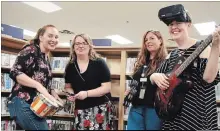  ?? KRIS DUBE
THE WELLAND TRIBUNE ?? Cassandra Magazzeni from the City of Welland, left, Katelynn Best from Welland Museum, and Marla Bestward and Kerri Turner from Welland Public Library jam ahead of this weekend’s Culture Days celebratio­n.