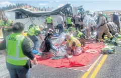  ?? AP ?? Emergency Medical Services personnel assist victims of a bus crash near Bryce Canyon National Park in southern Utah on Friday.