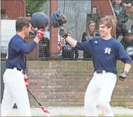  ??  ?? Lance Dockery (right) is all smiles as he gets a tip of the cap from teammate Luke Grant following Dockery’s second homer in Game 3 against Ridgeland on Friday night. Heritage swept the three-game set. (Photo by Scott Herpst)
Heritage 9, Ridgeland 2