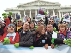  ??  ?? Rep. Luis Gutierrez, D-Ill., second from left, joins demonstrat­ors outside the Capitol on Dec. 6 in support of the Deferred Action for Childhood Arrivals (DACA) and Temporary Protected Status (TPS) programs. JOSE LUIS MAGANA/AP