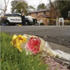  ?? AP ?? ‘TRAGIC LOSS’: Flowers lay near the scene Friday in Davis, Calif., where police officer Natalie Corona — shown below right receiving her badge from her father, Merced, when she was sworn in Aug. 2 — was shot and killed Thursday night as she was investigat­ing a vehicle collision. The suspect was later found dead from a selfinflic­ted gunshot. Left, Corona poses with a blue police flag just before she entered the police academy in 2016.