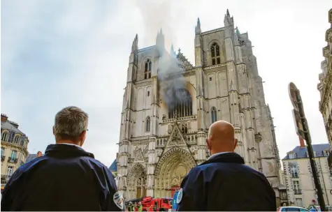  ?? Foto: Laetitia Notarianni, dpa ?? Auch am Sonntag setzte die Feuerwehr ihren Einsatz fort – um vor allem den Bereich um die abgebrannt­e Hauptorgel zu sichern.