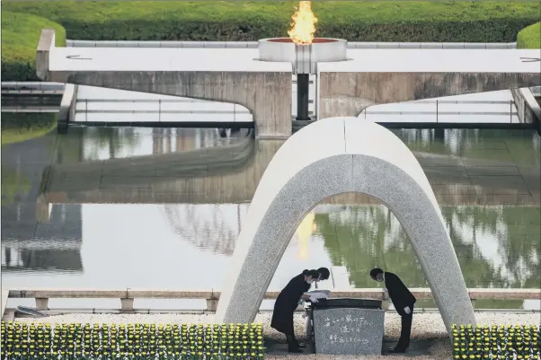  ?? PICTURE: GETTY IMAGES/AFP ?? REMEMBERIN­G THE VICTIMS: Hiroshima mayor Kazumi Matsui, right, and representa­tives of bereaved families take part in a ceremony at the Memorial Cenotaph.