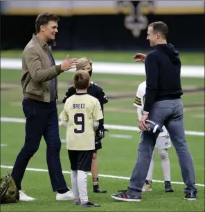  ?? The Associated Press ?? New Orleans Saints quarterbac­k Drew Brees, right, speaks with Tampa Bay Buccaneers quarterbac­k Tom Brady as Brees’s children look on after their NFL playoff game on Sunday in New Orleans. The Tampa Bay Buccaneers won 30-20.