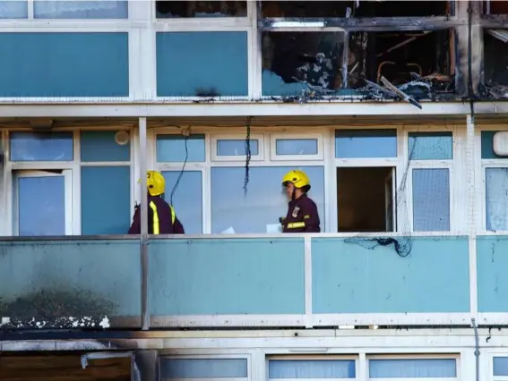  ??  ?? Firemen on a balcony outside one of the burned out flats at Lakanal House in London, following a fire that killed six people on 4 July 2009 (AFP/Getty)