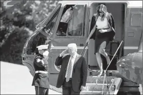  ?? AP/ANDREW HARNIK ?? President Donald Trump and first lady Melania Trump arrive Wednesday on the South Lawn of the White House in Washington.