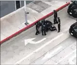  ?? Nicholas Flickinger ?? A STILL from video shows LAPD officers in Hollywood swarming a woman immobilize­d by a stun gun. Bystanders yelled for them to stop.