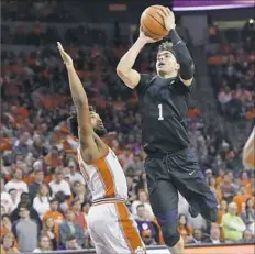  ?? Richard Shiro/Associated Press ?? Pitt’s Parker Stewart shoots over Clemson’s Gabe DeVoe in the first half.