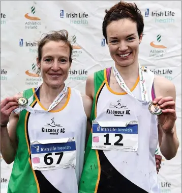  ??  ?? Fionnuala McCormack, left, with her sister Una Britton of Kilcoole A.C., after winning gold and bronze medals in the Senior Women event during the Irish Life Health National Senior, Junior & Juvenile Even Age Cross Country Championsh­ips at the National Sports Campus Abbotstown in Dublin.