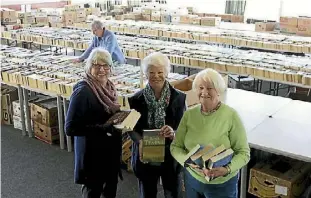  ??  ?? Mary Allan, Jenny Beckett and Philippa Robertson in front, with Cushla Clare sorting out books at the back.