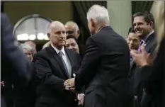  ??  ?? California Gov. Jerry Brown shakes hands with Assemblyma­n Tom Daly, D-Anaheim as walks to the podium to deliver his annual State of the State address before a joint session of the Legislatur­e, Thursday in Sacramento. AP PHOTO/RICH PEDRONCELL­I