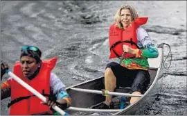  ?? Scott McIntyre Washington Post ?? JUDY PERKINS, right, paddles during a canoe race in Wilton Manors, Fla. New immunother­apy has helped Perkins achieve “complete durable cancer regression.”