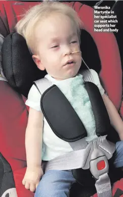  ??  ?? Weronika Martyniw in her specialist car seat which supports her head and body