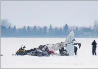  ?? CP PHOTO ?? Transport Safety Board and RCMP investigat­ors work at the scene of a fatal plane crash 11km outside of Brunkild, Man., on Friday, February 10, 2017. Two men were killed in the crash.