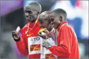  ??  ?? Silver medallist Uganda's Joshua Kiprui Cheptegei (L), gold medallist Britain's Mo Farah (C) and bronze medallist Kenya's Paul Kipngetich Tanui (R) on the podium after men's 10,000m race