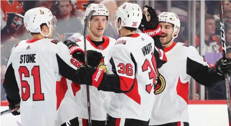  ?? BRUCE BENNETT/GETTY IMAGES ?? The Ottawa Senators celebrate a goal by Thomas Chabot, second from left, Tuesday in Philadelph­ia. Brady Tkachuk, with two, and Matt Duchene, with the game-winner, also scored.