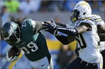  ?? MARK J. TERRILL — THE ASSOCIATED PRESS ?? Eagles running back LeGarrette Blount, left, delivers a stiff arm to Chargers defensive back Desmond King (20) during the second half of Sunday’s game.