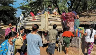  ?? ?? Caught in the middle: refugees, who earlier fled a flare-up in fighting between the myanmar army and ethnic minority rebels, preparing to voluntaril­y return across the border to myanmar at a pier in mae sot district, Tak province in Thailand. — reuters