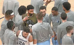  ?? JOE RONDONE/THE COMMERCIAL APPEAL ?? Grizzlies forward Jaren Jackson Jr., seen surrounded by teammates before their March 10 game at Washington, is expected to return later this month and could be enough to be hopeful going into May.