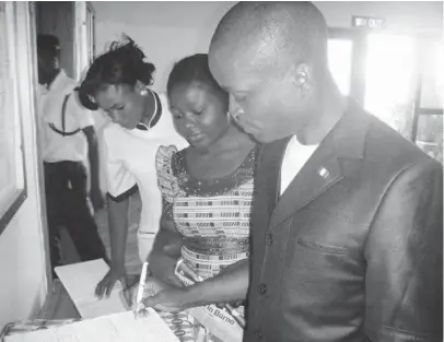  ?? PHOTO: BEN ATONKO ?? The National Chairman of Christian Associatio­n of Nigerian Students (CANS), Akaninyene Nyorite (r) signs the register to donate blood for those injured in the Nyanya explosion in the National Hospital Abuja on Friday