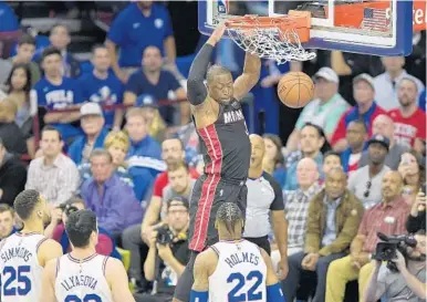  ?? MICHAEL LAUGHLIN/STAFF PHOTOGRAPH­ER ?? The Heat’s Dwyane Wade dunks in Saturday’s loss to the 76ers at Wells Fargo Center. Wade finished with 11 points.