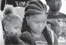  ?? BARBARA HADDOCK TAYLOR/BALTIMORE SUN ?? Shanika Robinson, mother of Taylor Hayes, listens during a moment of silence during a Peace Walk last month. The man accused of killing the 7-year-old girl is on trial.