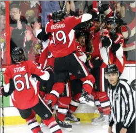  ?? ADRIAN WYLD — THE ASSOCIATED PRESS ?? The Ottawa Senators celebrate Jean-Gabriel Pageau’s game-winning overtime goal against the New York Rangers in Game 2 on Saturday.