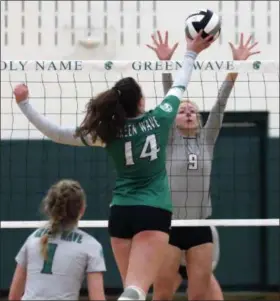  ?? RANDY MEYERS — THE MORNING JOURNAL ?? Mary Margaret Adams of Holy Name taps the ball over Rachel Waite of Rocky River at the net during the first set on Oct. 27.