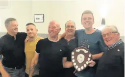  ??  ?? ■ S H Cox Division 3 Winners Bull & Bush Laughing Boys being presented with their trophy by division sponsor Steve Cox.