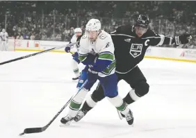  ?? RYAN SUN/THE ASSOCIATED PRESS FILES ?? Canucks forward Nils Hoglander, left, has a knack for being able to protect the puck.