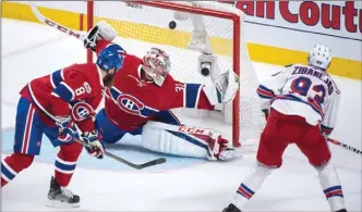  ?? The Canadian Press ?? New York Rangers centre Mika Zibanejad scores in overtime past Montreal Canadiens goalie Carey Price as defenceman Jordie Benn looks on during Game 5 of their NHL playoff series Thursday in Montreal. The Rangers won 3-2 and lead the series 3-2.