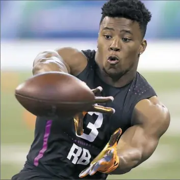  ?? Darron Cummings/Associated Press photos ?? Saquon Barkley displayed the combinatio­n of strength, speed and quickness at the NFL Scouting Combine that has him a projected top-five pick in April’s draft.