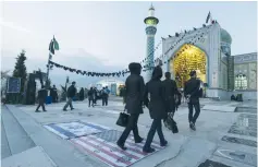  ?? (Reuters) ?? IRANIANS TREAD on US and Israeli flags on their way to a shrine in northern Tehran on the Ashura holiday on October 24, 2015.