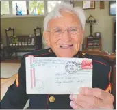  ?? (AP/Terry Chea) ?? Jerry Pedersen, 95, holds a letter he sent to his family from aboard the USS Missouri in Tokyo Bay on Sept 2, 1945, while watching a livestream ceremony at his son’s home in West Sacramento, Calif. He was among the American soldiers on the ship when U.S. and Japanese officials signed papers that officially ended the World War II 75 years ago.