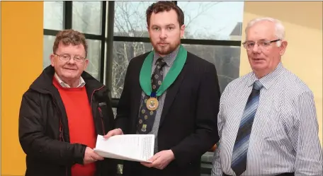  ??  ?? Donore residents Joe McKane and Vincent Donovan hand a petition to Cllr. Paddy Meade.