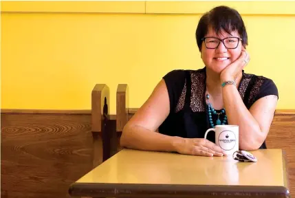  ??  ?? University of Waterloo’s Melanie Goodchild, posing in the Crystal Ball Beach Café in Crystal Beach, the small Niagara Region community she currently calls home, proudly displays visual reminders on her arms of her orca spirit helpers and her ‘biker chick’ persona.