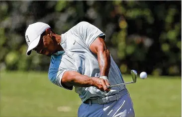  ?? KEVIN C. COX / GETTY IMAGES ?? Healthy and a contender again, Tiger Woods prompted ratings to climb 26 percent in the first round of the Tour Championsh­ip at East Lake Golf Club in Atlanta. He finished Round 2 on Friday tied for the lead.