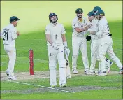  ?? AFP ?? England's batsman Ollie Robinson (C) walks off as Australian players celebrate his dismissal at Adelaide on Monday.